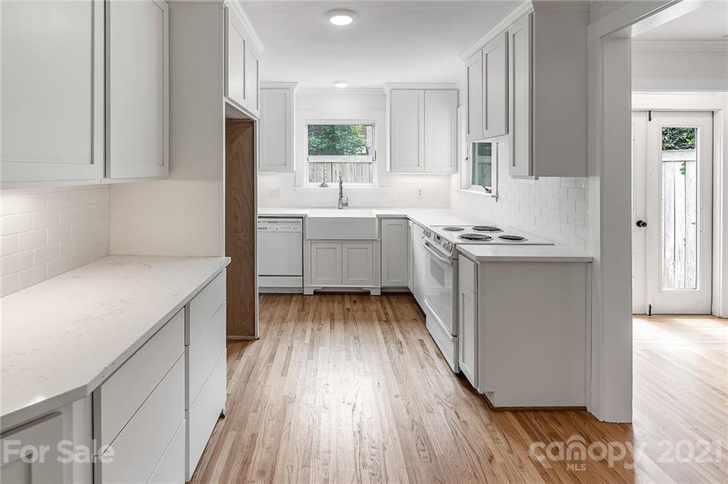 327 Marsh Road Charlotte, NC 28209 - Photo 17 of 48 a kitchen with a sink stove and cabinets