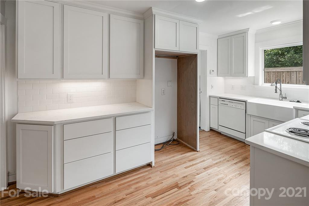 327 Marsh Road Charlotte, NC 28209 - Photo 18 of 48 a kitchen with a sink cabinets and wooden floor
