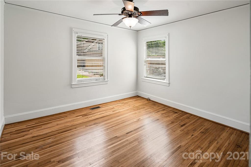 327 Marsh Road Charlotte, NC 28209 - Photo 20 of 48 a view of an empty room with wooden floor and a window