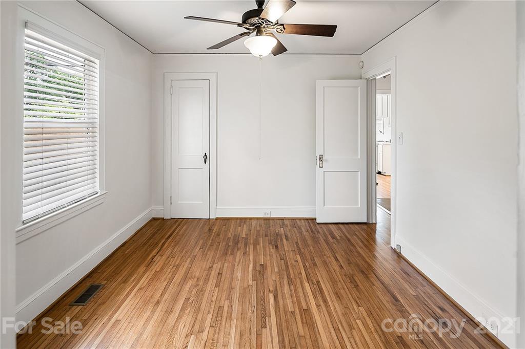 327 Marsh Road Charlotte, NC 28209 - Photo 23 of 48 a view of an empty room with wooden floor and a window