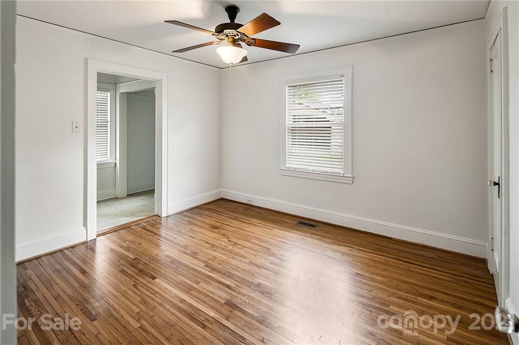 327 Marsh Road Charlotte, NC 28209 - Photo 26 of 48 a view of an empty room with wooden floor and a window