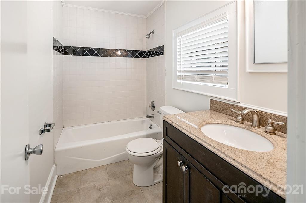 327 Marsh Road Charlotte, NC 28209 - Photo 27 of 48 a bathroom with a granite countertop sink a toilet and bathtub