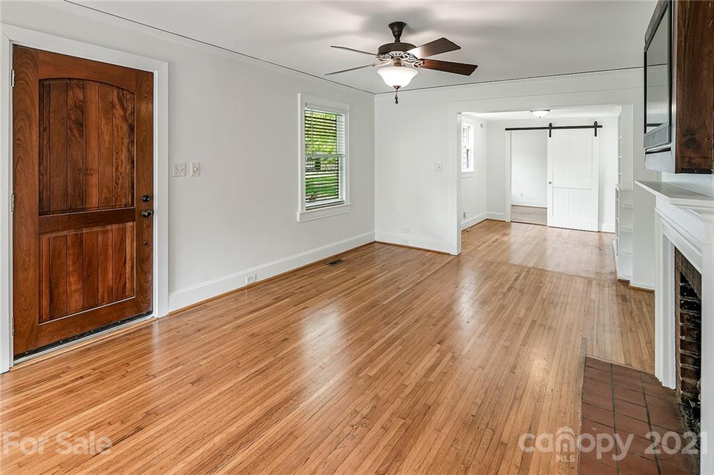 327 Marsh Road Charlotte, NC 28209 - Photo 4 of 48 a view of empty room with wooden floor and fan