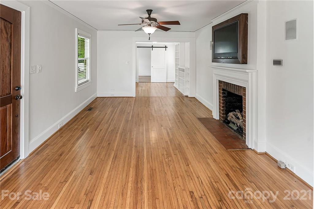 327 Marsh Road Charlotte, NC 28209 - Photo 5 of 48 a hallway with wooden floor fireplace and windows