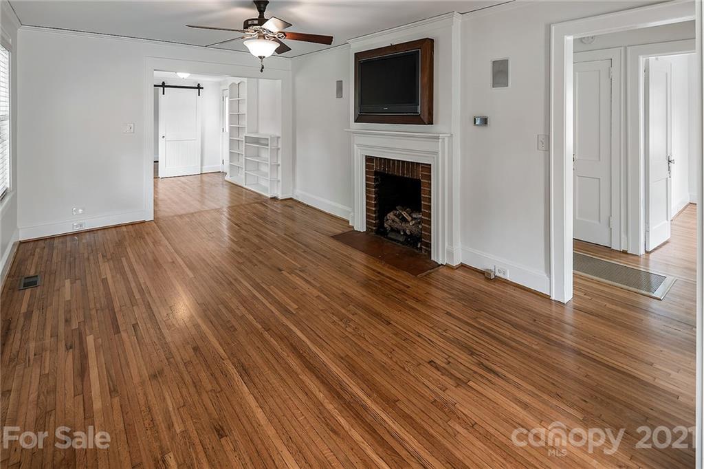 327 Marsh Road Charlotte, NC 28209 - Photo 6 of 48 a view of an empty room with wooden floor and a fireplace