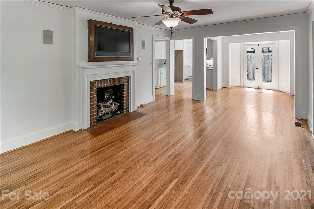 327 Marsh Road Charlotte, NC 28209 - Photo 7 of 48 a view of a livingroom with a fireplace wooden floor windows and a fireplace