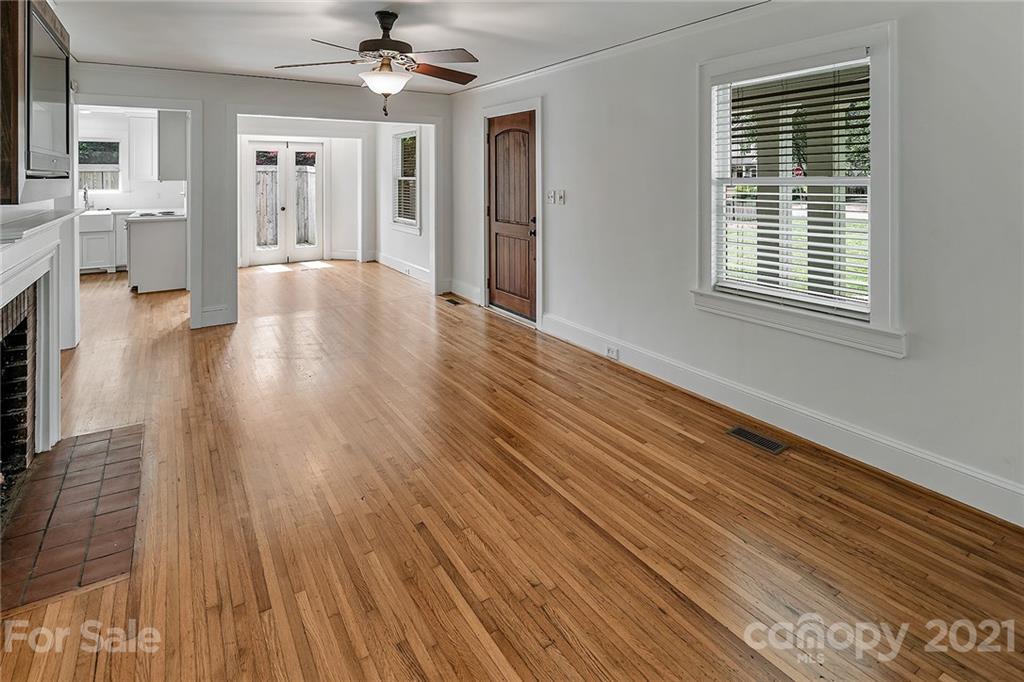 327 Marsh Road Charlotte, NC 28209 - Photo 8 of 48 a view of a livingroom with wooden floor and a ceiling fan