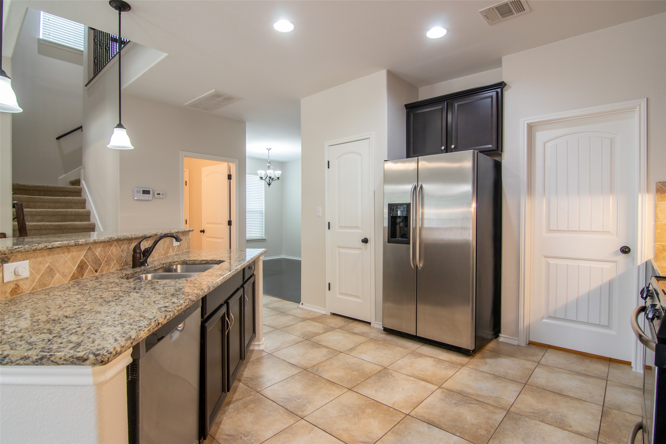 12104 Broten Street Austin, TX 78748 - Photo 8 of 32 A well-appointed kitchen showcasing granite counters and stainless steel appliances.