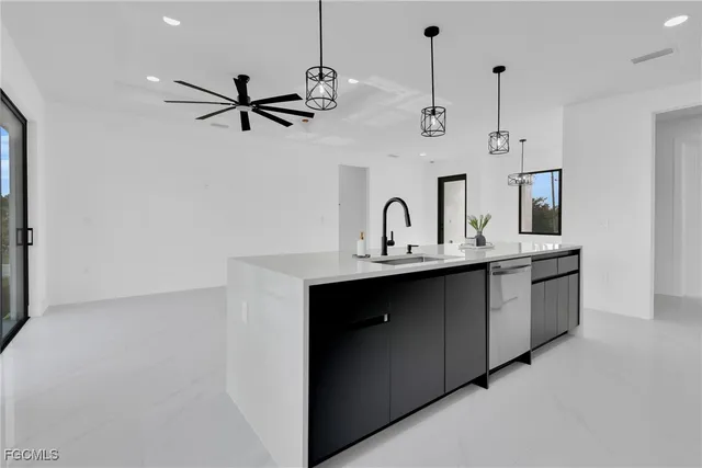 a kitchen with kitchen island granite countertop a sink stainless steel appliances and cabinets