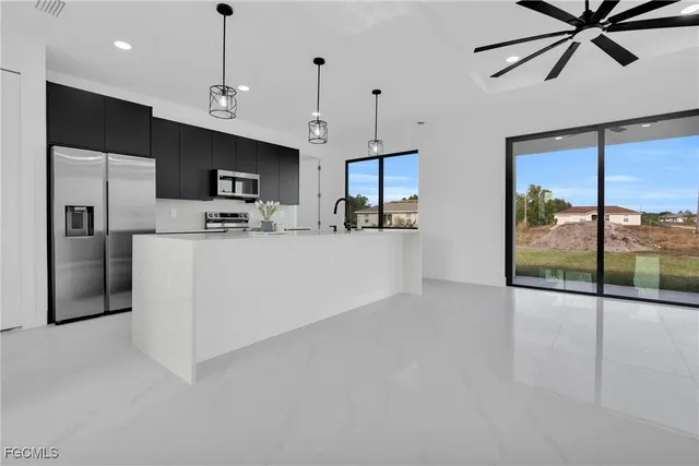 a kitchen with a sink appliances and a counter top space