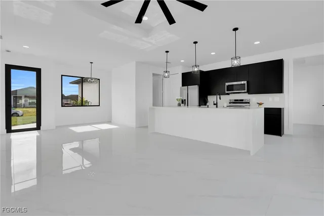 a kitchen with a sink a refrigerator and a stove