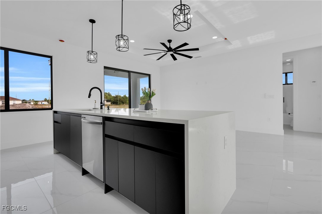 3602 20th Street Southwest Lehigh Acres, FL 33976 - Photo 23 of 40 a kitchen with a sink a refrigerator and a stove