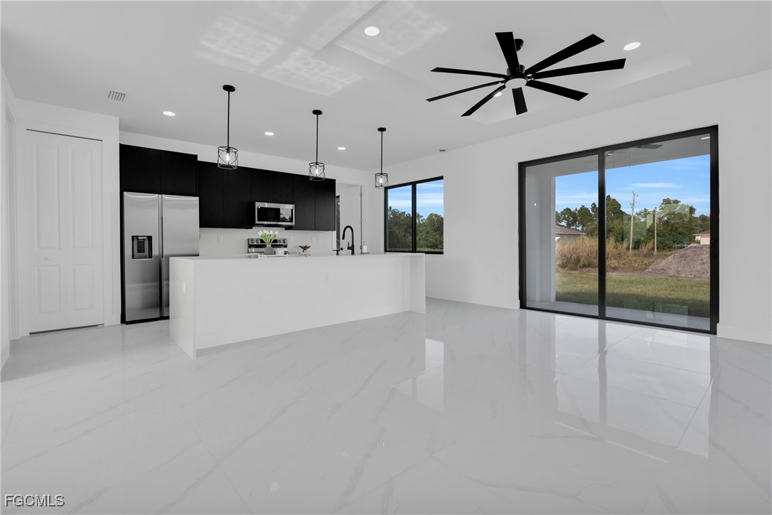 3602 20th Street Southwest Lehigh Acres, FL 33976 - Photo 24 of 40 a view of a kitchen with a sink and a ceiling fan