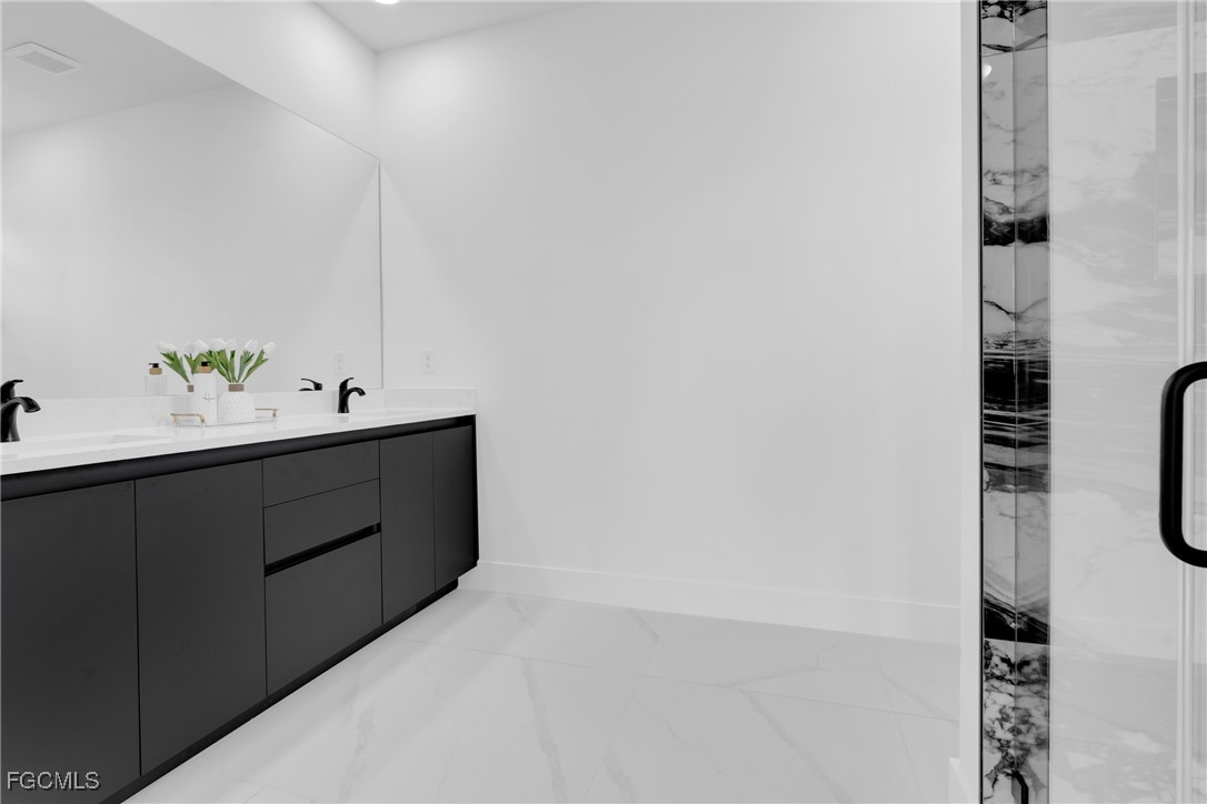 3602 20th Street Southwest Lehigh Acres, FL 33976 - Photo 27 of 40 a utility room with cabinets and wooden floor