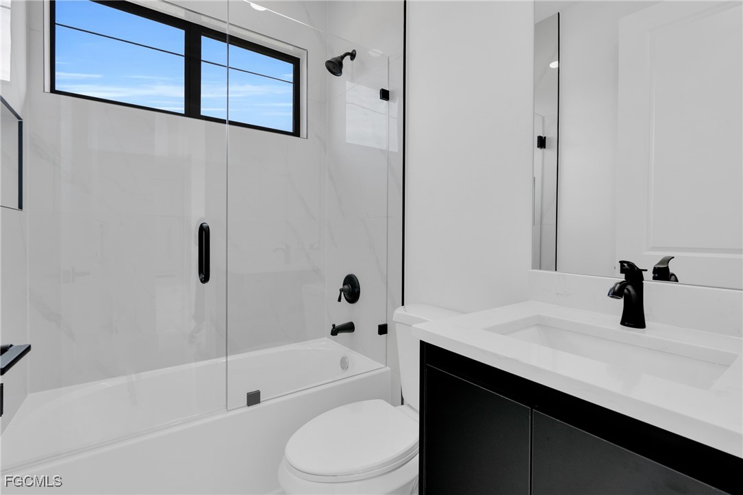 3602 20th Street Southwest Lehigh Acres, FL 33976 - Photo 37 of 40 a bathroom with a sink a toilet and bathtub