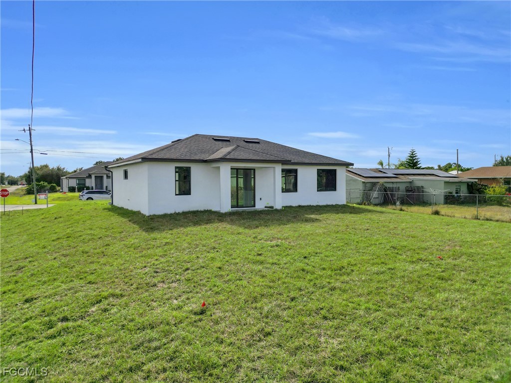 3602 20th Street Southwest Lehigh Acres, FL 33976 - Photo 6 of 40 a front view of a house with a garden