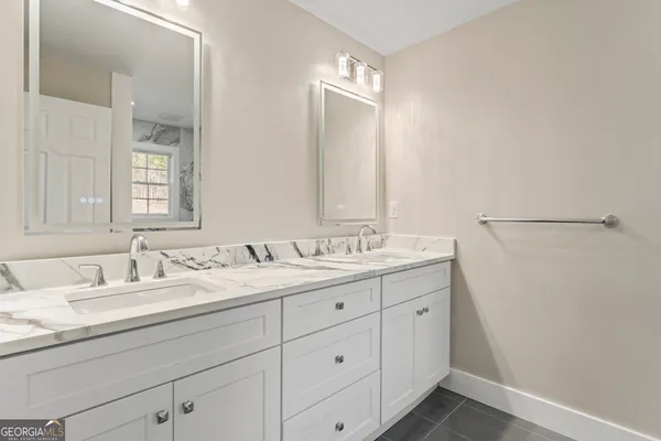 a bathroom with a double vanity sink and a mirror