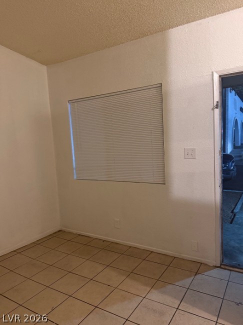 521 North Decatur Boulevard, Unit B Las Vegas, NV 89107 - Photo 2 of 17 A window with blinds offers natural light into this tiled interior space.
