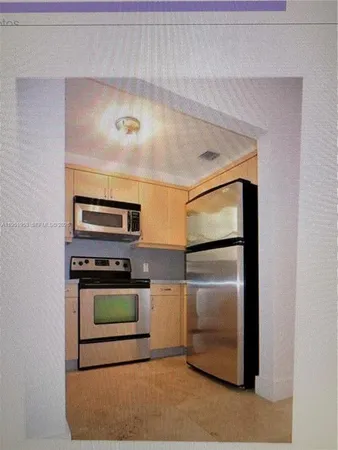 a kitchen with a refrigerator stove and oven