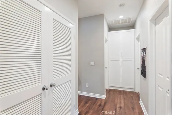a view of a hallway with wooden floor