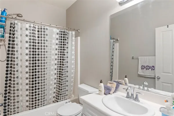 a bathroom with a sink a toilet and a shower