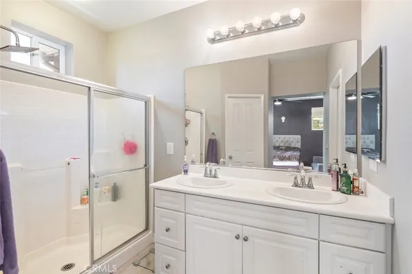 a bathroom with a sink vanity tub and shower