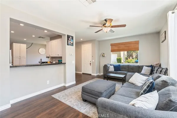 a living room with furniture and a ceiling fan