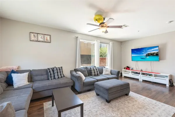 a living room with furniture and wooden floor