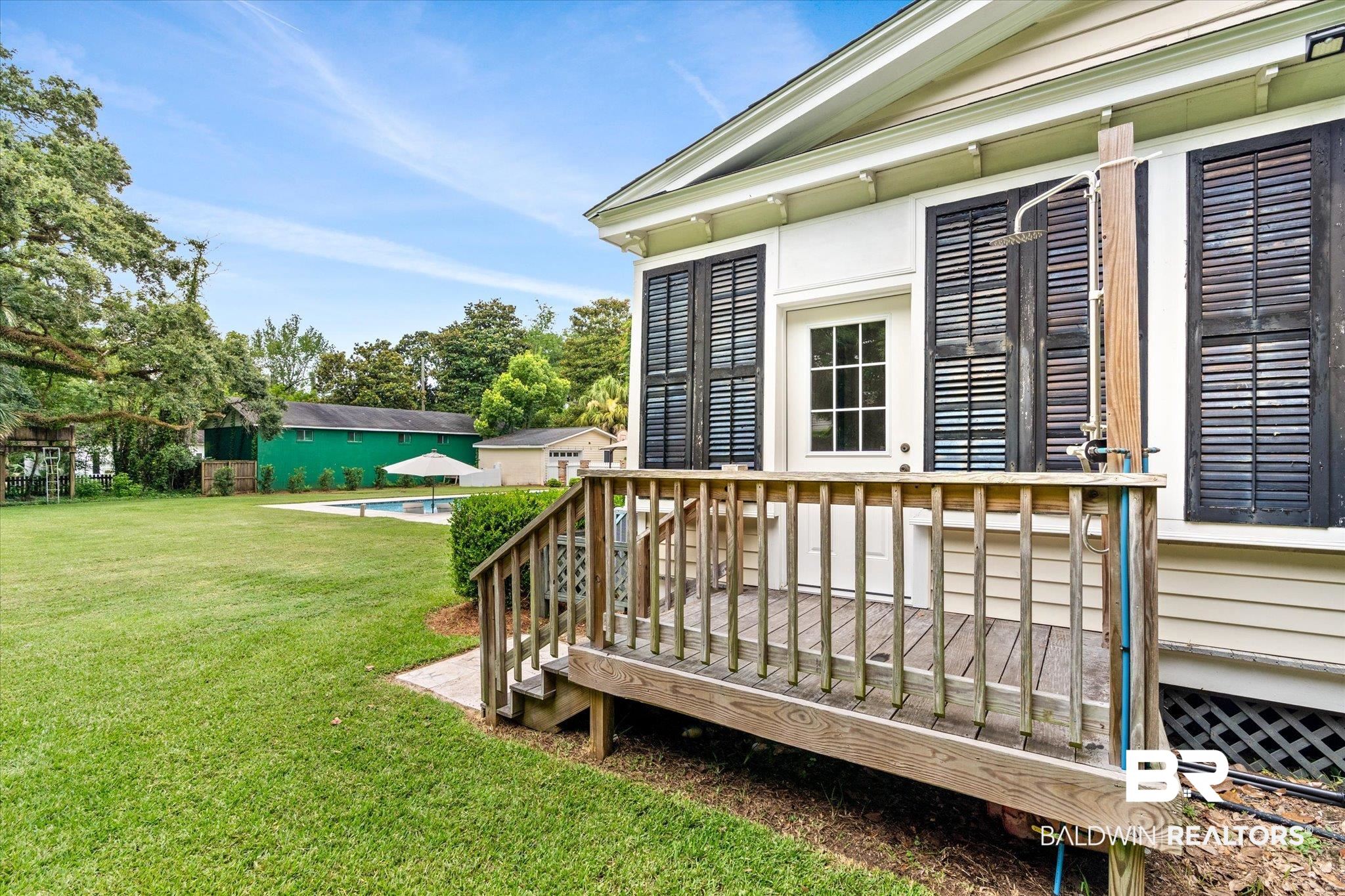 2205 Spring Hill Avenue Mobile, AL 36607 - Photo 39 of 59 Wooden terrace featuring a yard and a pool