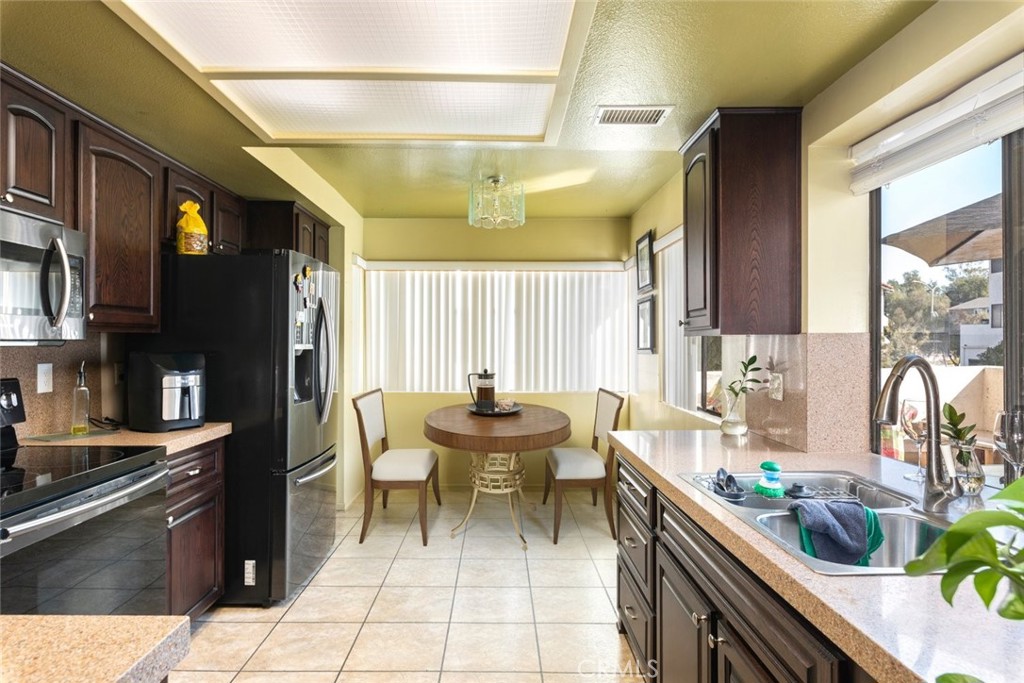 1441 Summit Drive Chula Vista, CA 91910 - Photo 11 of 29 a kitchen with a sink and chairs