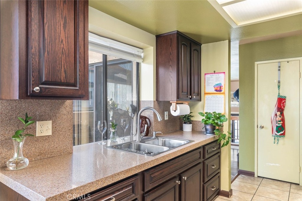 1441 Summit Drive Chula Vista, CA 91910 - Photo 13 of 29 a kitchen with stainless steel appliances granite countertop a sink and a refrigerator