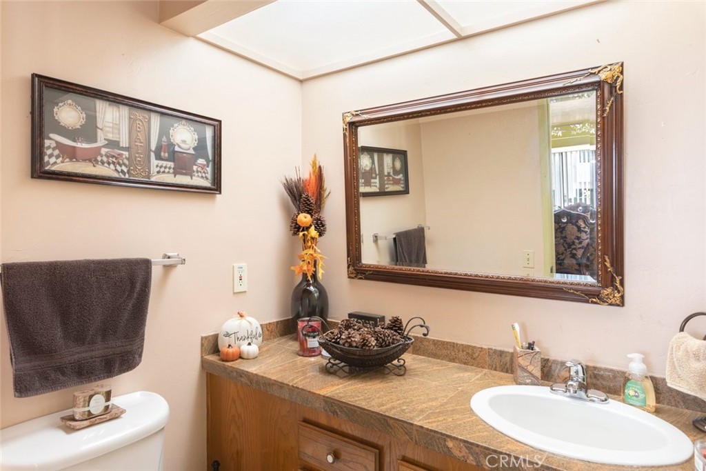 1441 Summit Drive Chula Vista, CA 91910 - Photo 14 of 29 a bathroom with a toilet a sink and mirror
