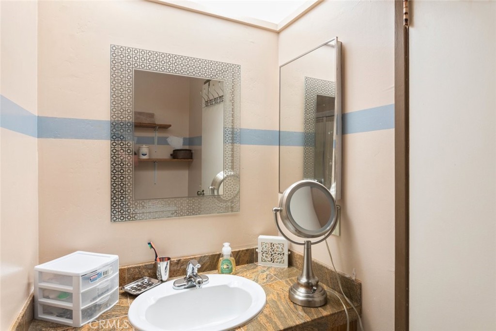 1441 Summit Drive Chula Vista, CA 91910 - Photo 17 of 29 a bathroom with a granite countertop sink and a mirror