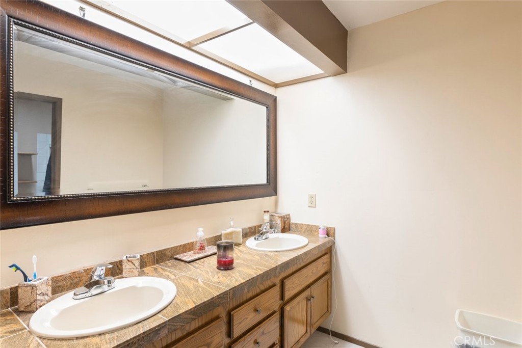 1441 Summit Drive Chula Vista, CA 91910 - Photo 21 of 29 a bathroom with a sink and a mirror