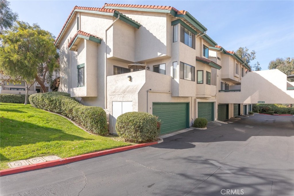 1441 Summit Drive Chula Vista, CA 91910 - Photo 23 of 29 a view of a white house with a yard and plants