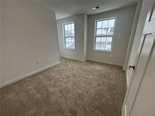 a view of an empty room and fire place
