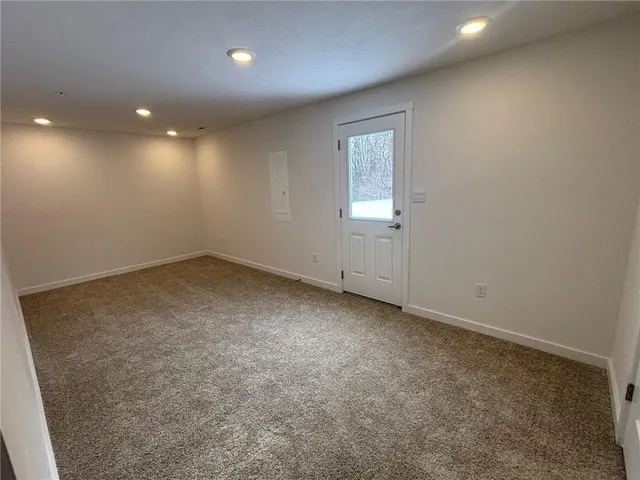 an empty room with a empty space and windows