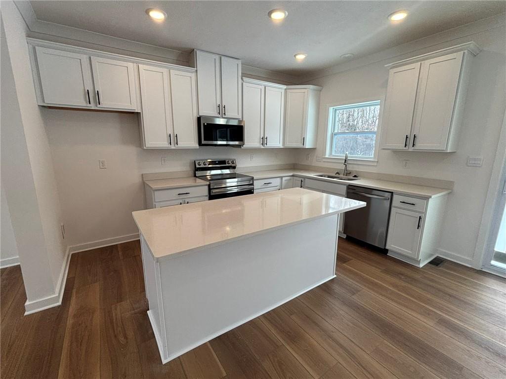 176 Lockheed Drive Coraopolis, PA 15108 - Photo 8 of 21 a kitchen with stainless steel appliances a sink a stove a refrigerator cabinets and a wooden floor