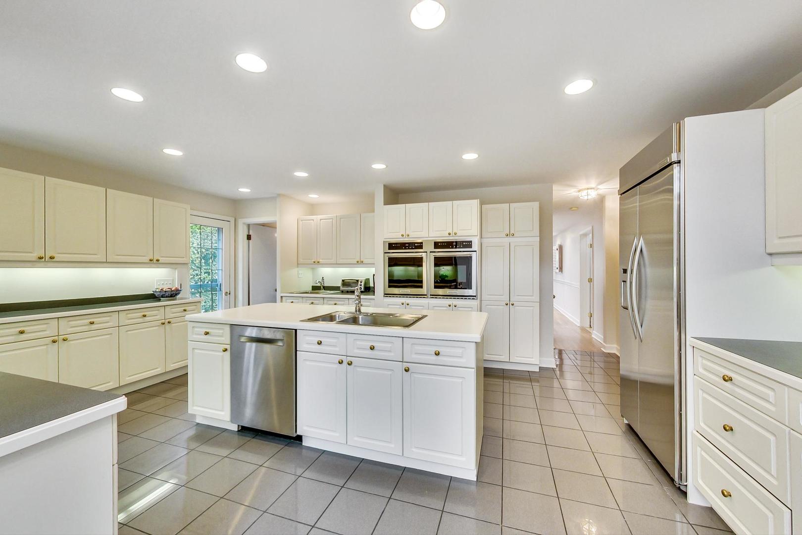180 Westview Road Winnetka, IL 60093 - Photo 12 of 31 a kitchen with white cabinets appliances and a sink