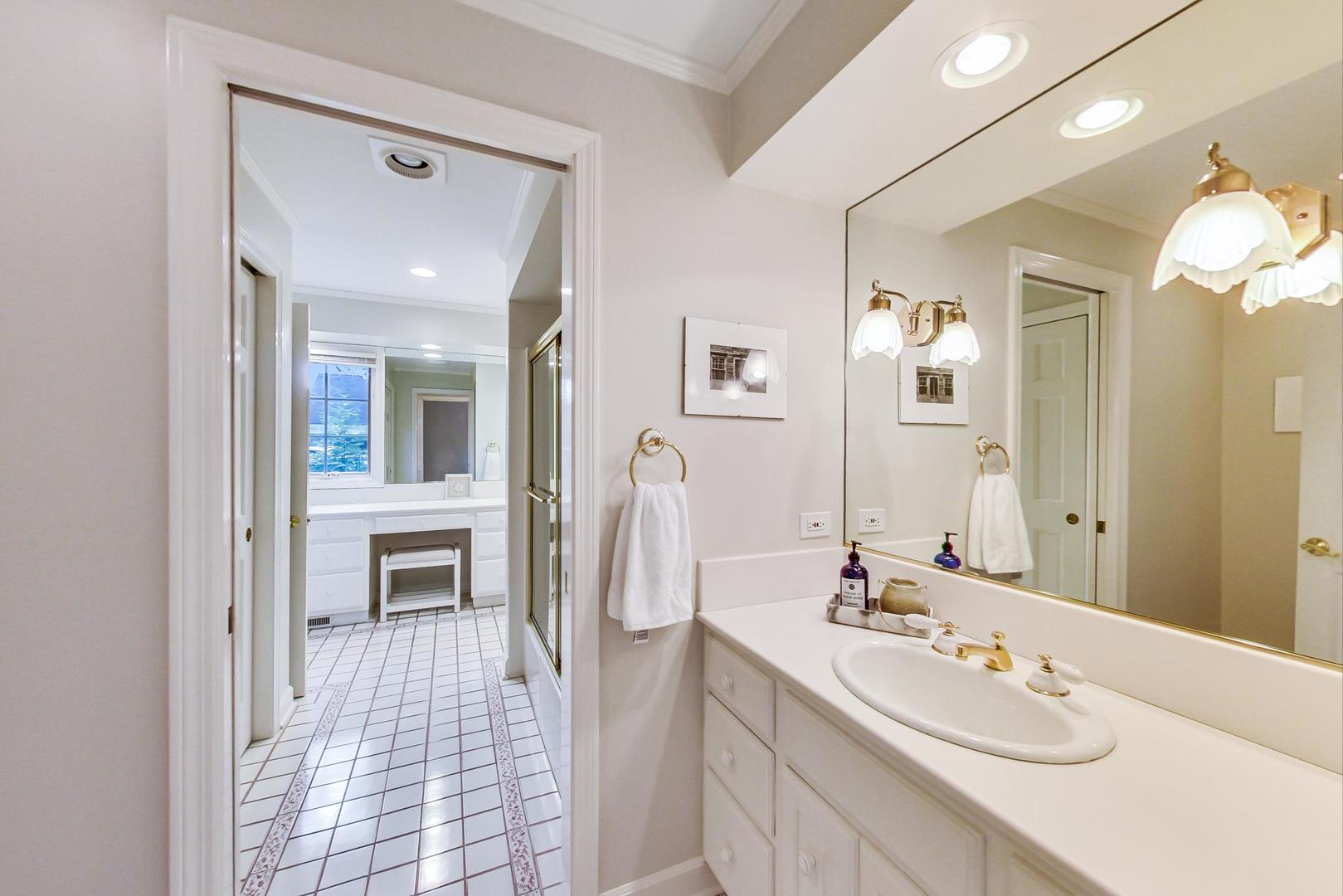 180 Westview Road Winnetka, IL 60093 - Photo 23 of 31 a spacious bathroom with a sink double vanity and a mirror