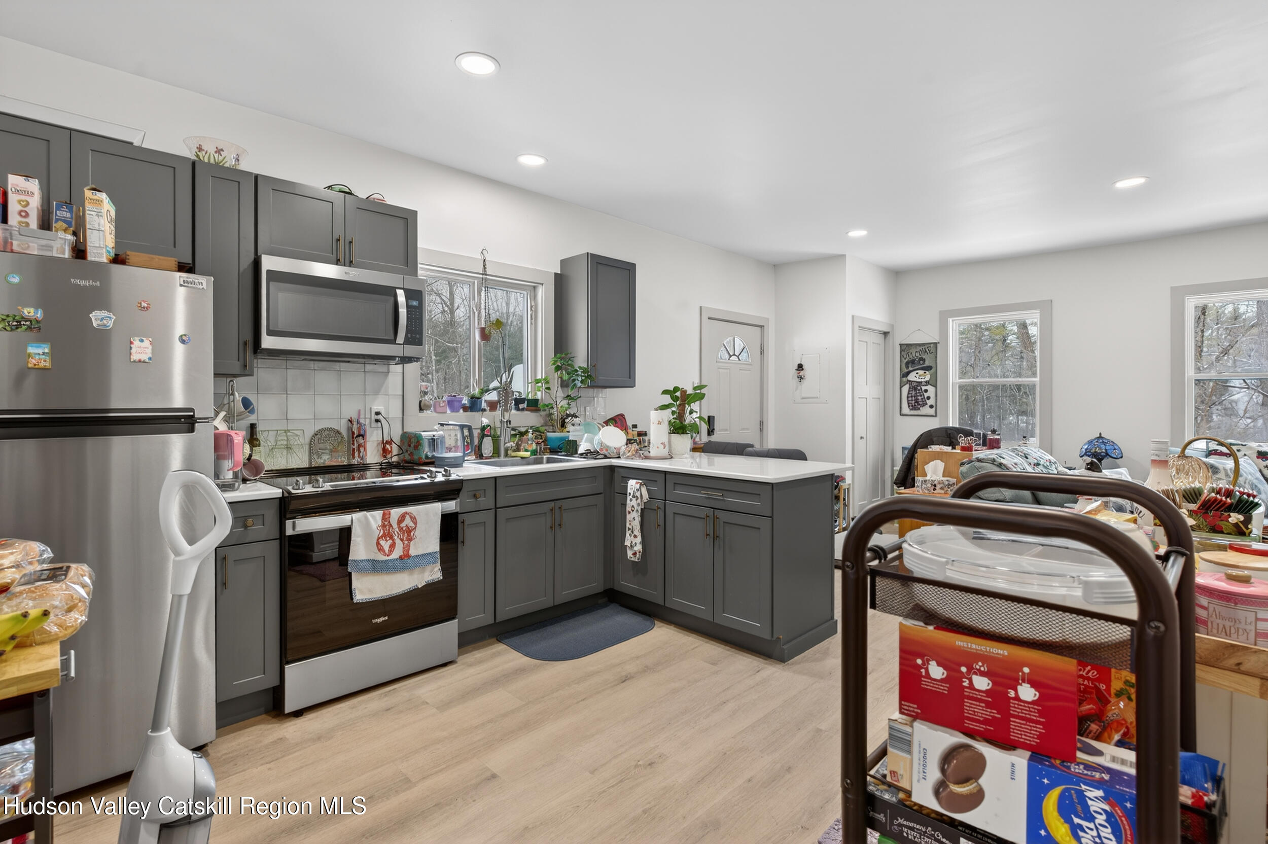 3-5 Dutchtown Road Saugerties, NY 12477 - Photo 17 of 25 a kitchen with stainless steel appliances kitchen island granite countertop a sink refrigerator and microwave