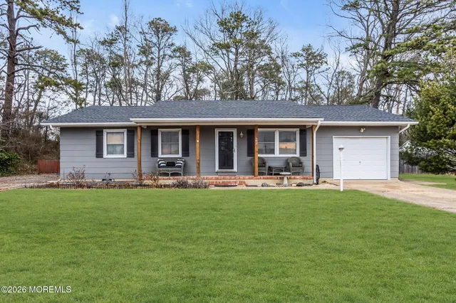 a front view of a house with swimming pool having outdoor seating