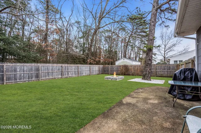 a view of a backyard with furniture and a tree