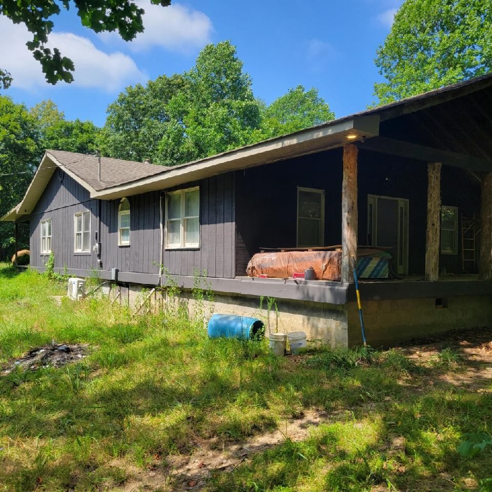 1376 Panhandle Road Manchester, TN 37355 - Photo 12 of 13 a backyard of a house with table and chairs under an umbrella