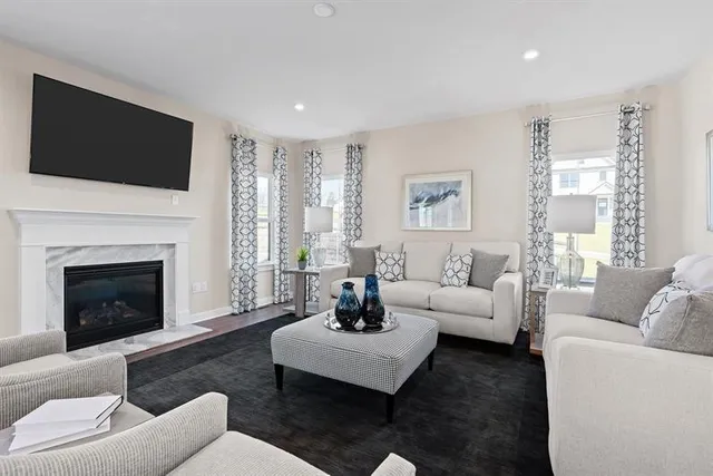 a living room with furniture fireplace and window