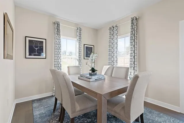 a view of a dining room with furniture and window