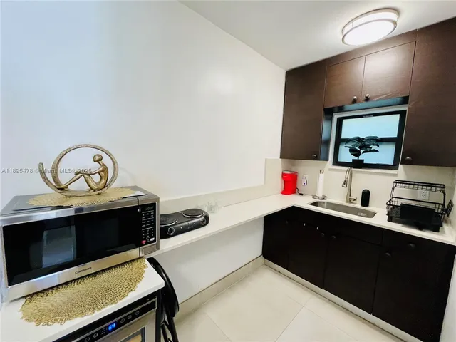 a utility room with sink dryer and washer