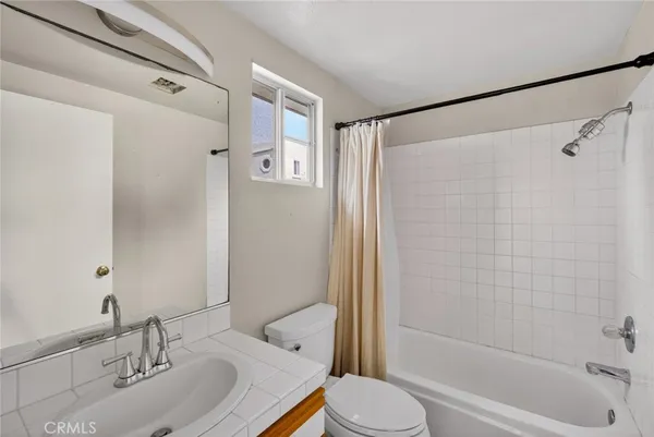 a bathroom with a shower curtain and a bathtub