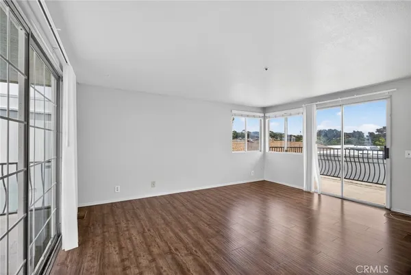 a view of a room with wooden floor and windows