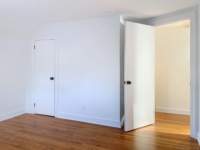 a view of a room with wooden floor